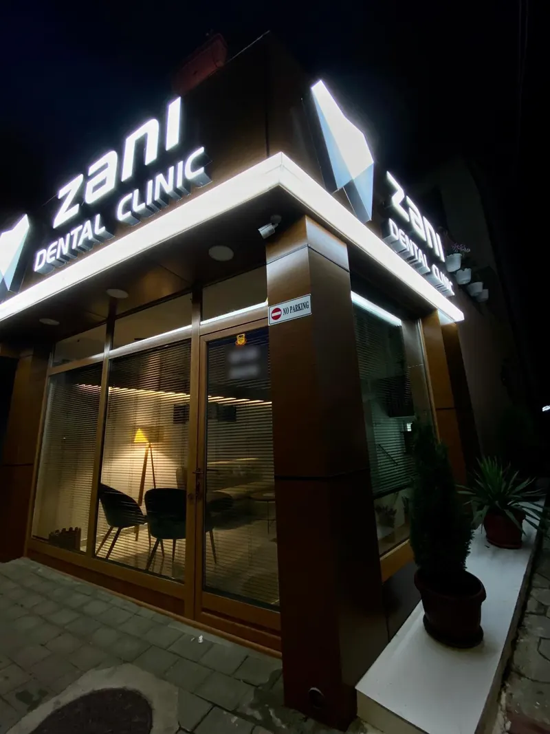 The clinic’s corner at night with the lit sign