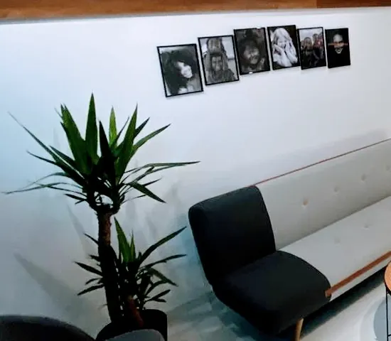 Black-and-white smile portraits on the waiting-room wall