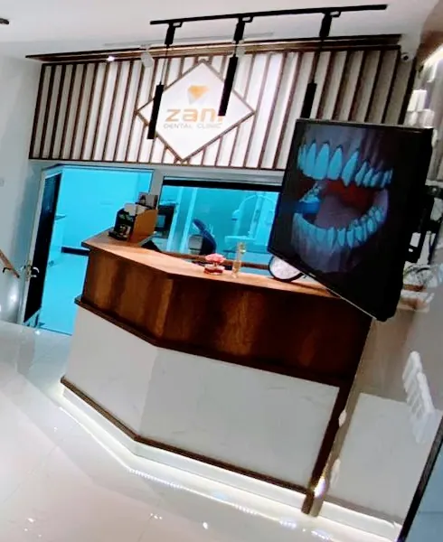 Reception desk with the Zani logo and a screen