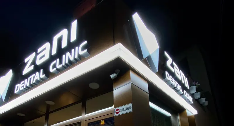 The clinic’s corner sign lit up at night