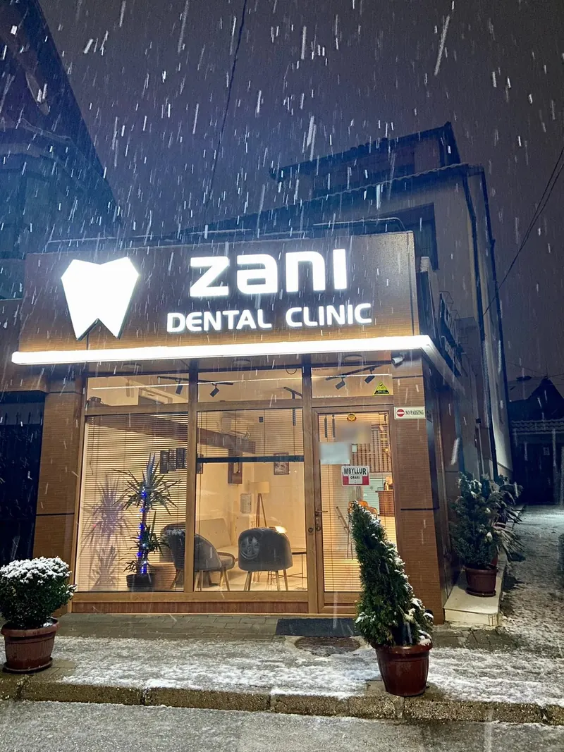 The clinic’s glowing shopfront in falling snow